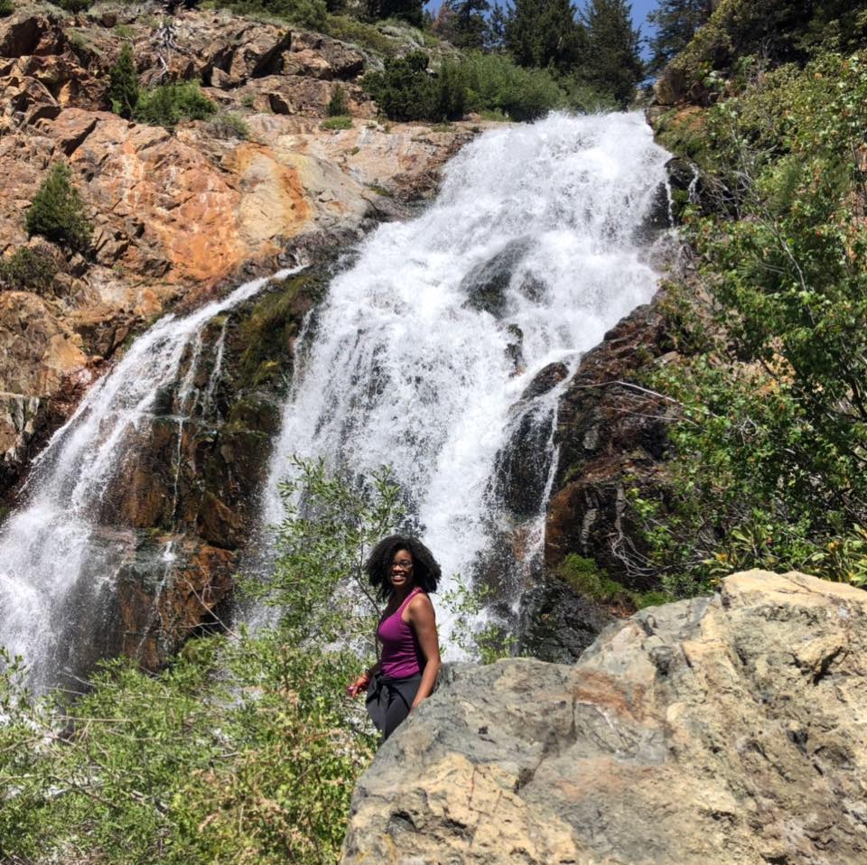 Caprice Phillips in front of waterfall